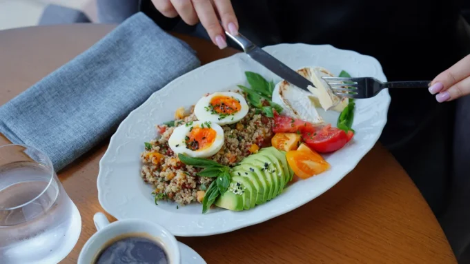 Kan şekeri beslenme tabağı Kinoa, haşlanmış yumurta, avokado, domates ve yeşilliklerle hazırlanmış dengeli öğün tabağı ve yanında su